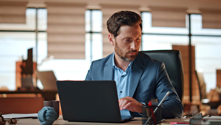 Man in suit working on laptop